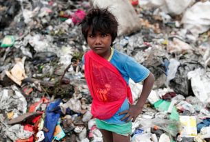 A Bradford child plays among the rubbish